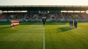 Voetbalveld vanuit het midden gezien met twee teams opgesteld voor de aftrap